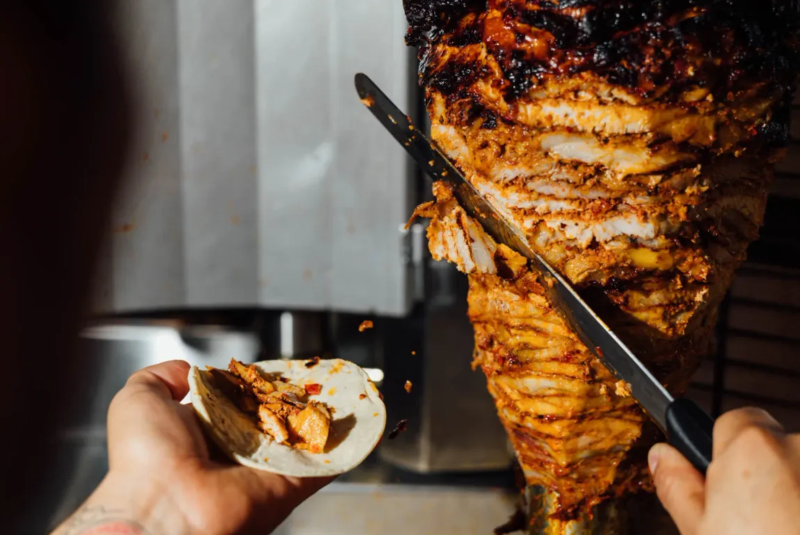 Al pastor being carved fresh off the trompo