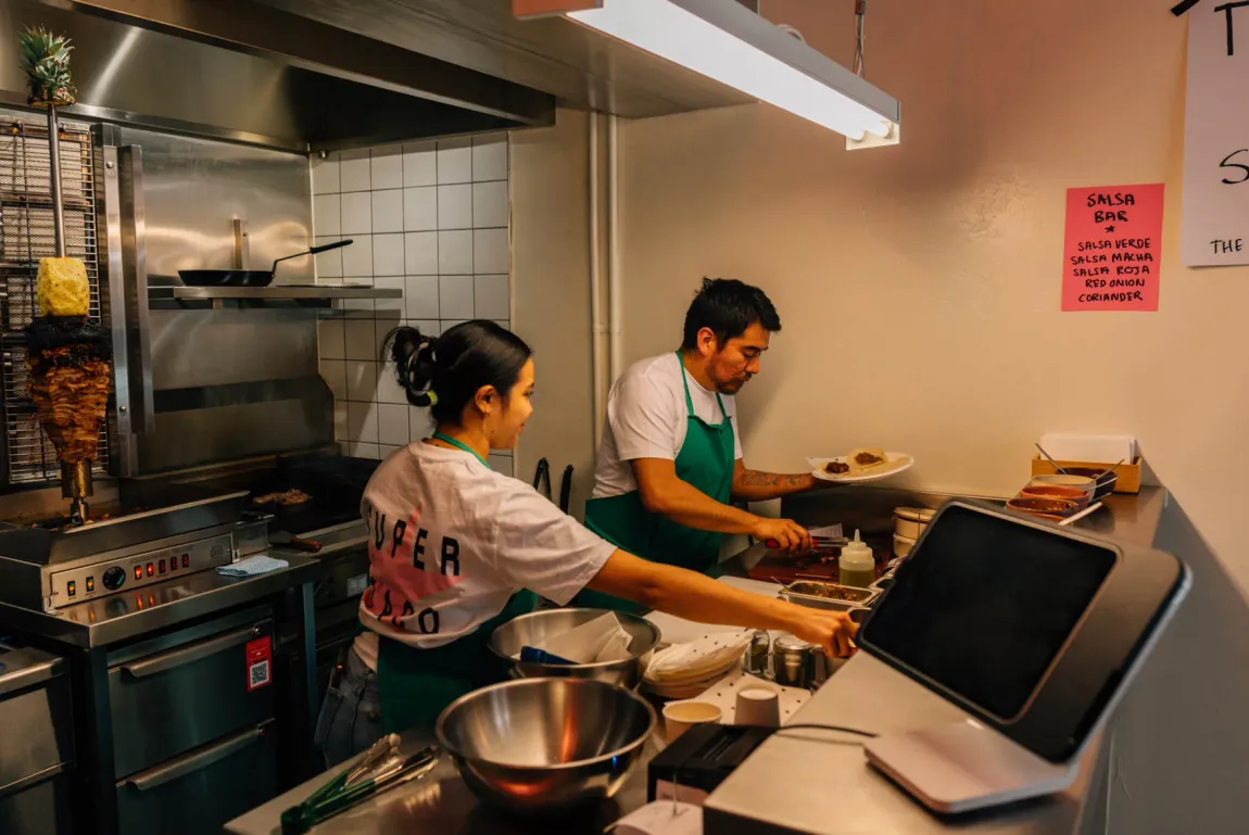 Cooks plating tacos in the Super Taco kitchen