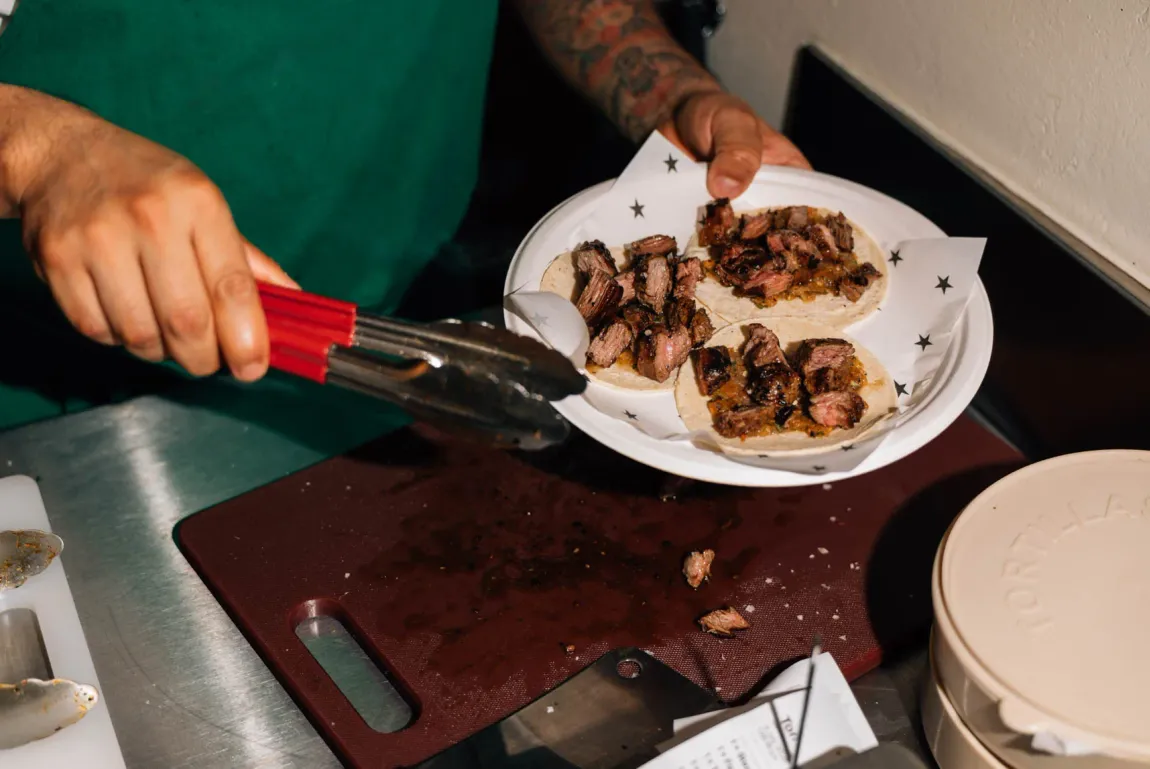 Skirt steak tacos being built to order