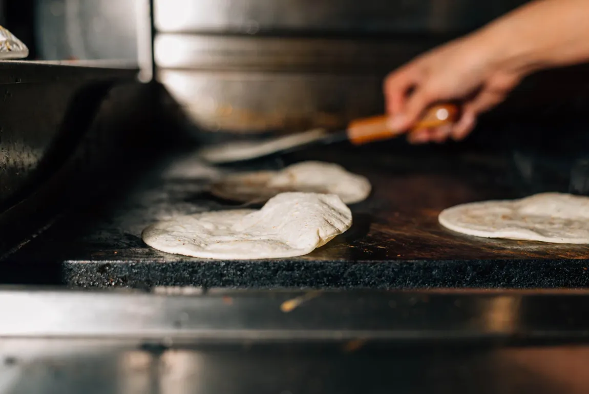 Tortillas warming on the flat-top griddle